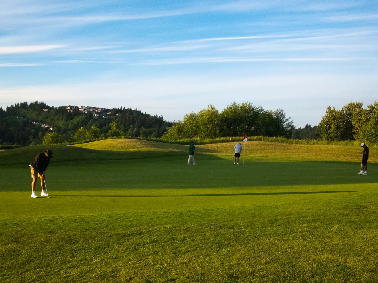 Players putting on a wide green during a relaxed 18 Holes to Home round